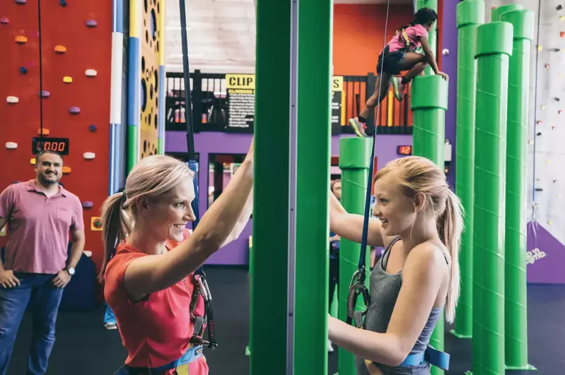 mother and daughter climbing while facing each other