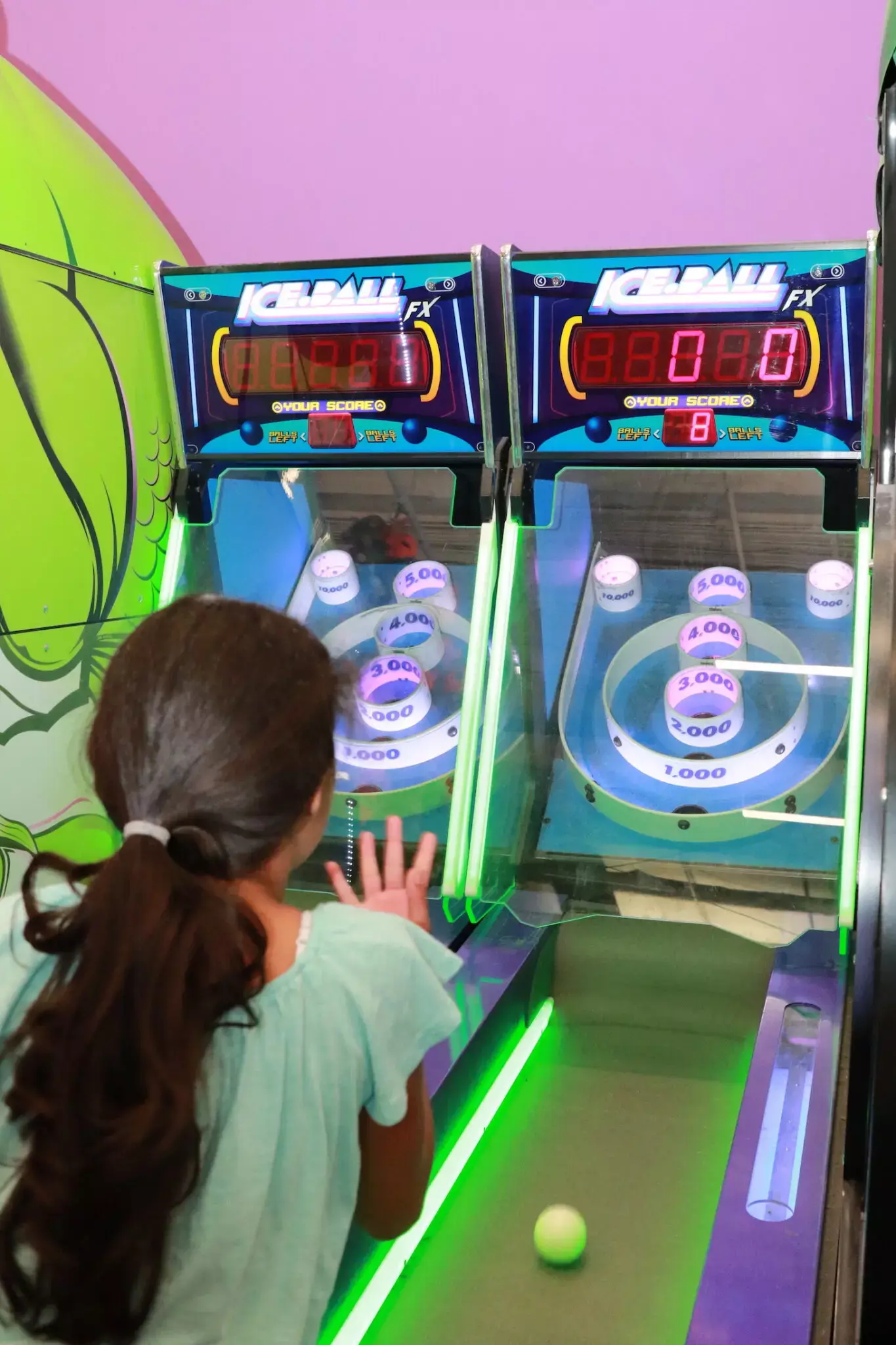 girl playing skeeball